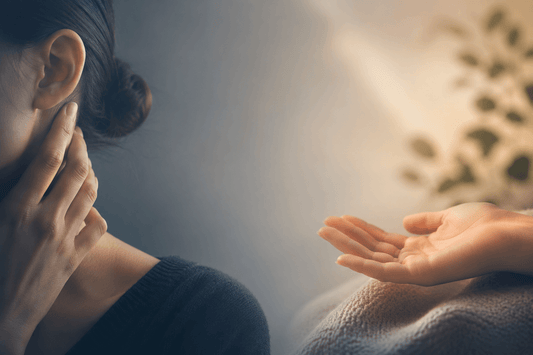 A lady with her hand near the vagus nerve on her neck and an open palm side by side